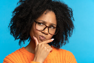Thoughtful african woman look away holding hand on chin. Pensive mixed race girl student or...