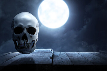 Human skull on wooden table