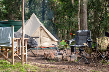 Family tent setup at the campsite surrounding by nature in holiday park - obrazy, fototapety, plakaty