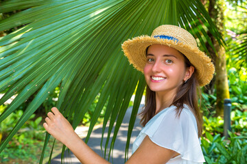 Woman and large tropical palm leaves