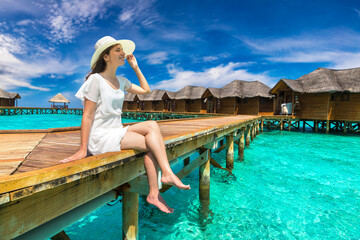 Woman sitting on the wooden pier