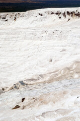 Pamukkale travertine texture. Wavy limestone textured deposits on terraces of carbonate minerals in Pamukkale, Turkey.