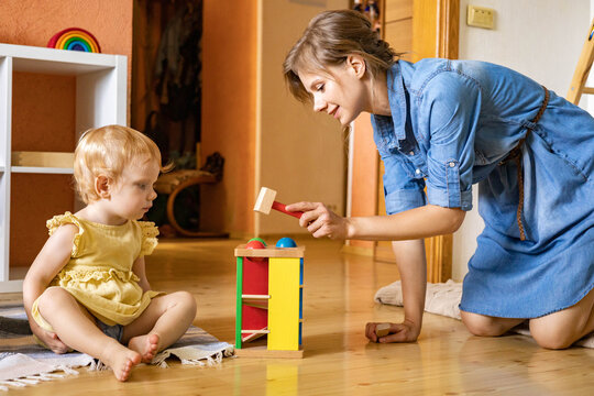 Happy Mother Playing Toddler Hitting Wooden Hammer On Colored Balls Early Development Ecological Toy