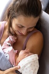 Mother holding newborn baby girl- close up
