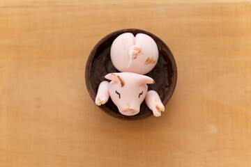 top view of decorated candy, happy cute pink pigs playing in the mud