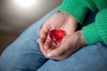 Woman hand holding red gift. Red heart. Love concept. Valentine day. 