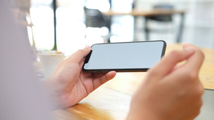 Close up of man hand holding smart phone.