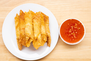 Fried pork wontons with  sauce.