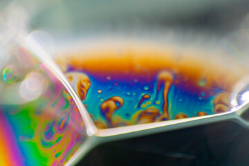 View into a microscopic world of soap bubbles, uncovered light, artistic multicolored surreal detail.