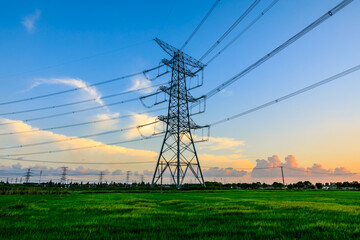 High voltage power tower industrial landscape at sunrise,urban power transmission lines.