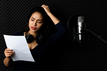 Pity Asian woman singer exhausted with note paper in hand, feel stressed on singing, worry of...