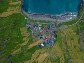 Beautiful aerial view of the Tjornuvik village in the middle of the Mountains in Faroe Island