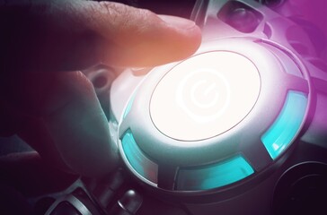 Finger about to press a car ignition button with copy for text. Composite image between a hand photography and a 3D background.