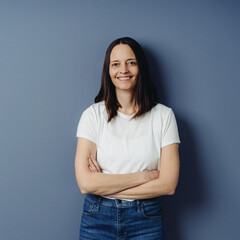 Smiling relaxed middle-aged woman in jeans and t-shirt
