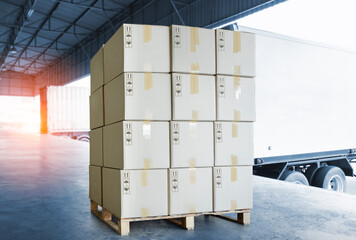 Stack of Package Boxes on Pallets Load with Shipping Cargo Container. Truck Parked Loading at Dock Warehouse. Delivery. Warehouse Logistics. Cargo Freight Truck Transportation.
