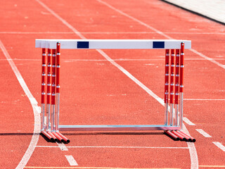 Hurdles and red running tracks in a stadion