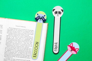Cute bookmarks with book on color background
