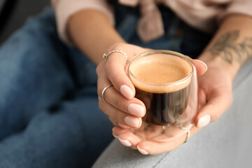 Woman drinking tasty coffee at home, closeup