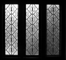 light gradient on three translucent glasses of identical windows with vintage designs symmetric pattern 