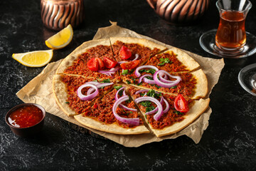 Delicious Turkish pizza on dark background