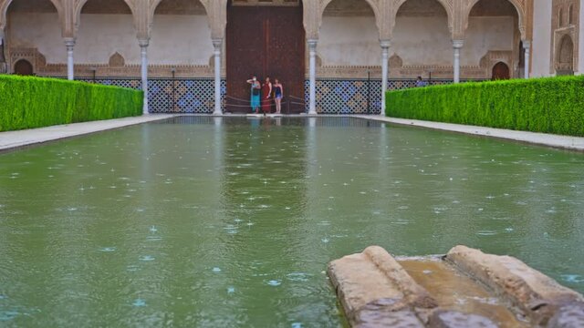 Rainy day at the pool of Courtyard of the Myrtles in Alhambra, Granada, Spain