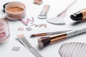 Makeup brushes with drawings on white background, closeup