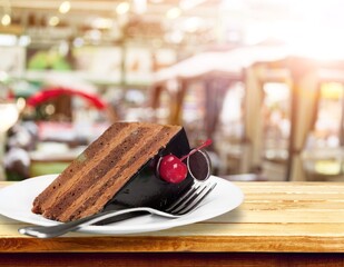 Pieces of fresh brownie with chocolate topping on table. Delicious chocolate pie.