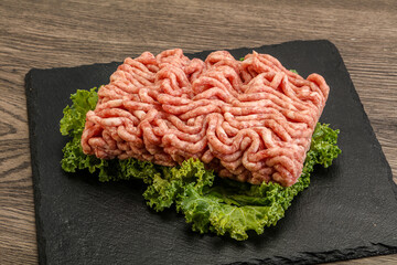 Raw pork minced meat over board