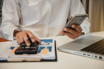 Fototapeta premium Businessmen are calculating income-expenditure and analyzing real estate investment data at office.