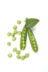 Pods of green peas with leaves isolated on white background