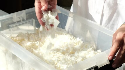 white soy wax flakes for candle making. Light texture of soy wax flakes. Ingredient for homemade candles. Ecological lifestyle