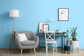 Interior of stylish room with modern workplace and pictures