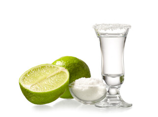 Shot of tasty tequila with lime and salt on white background