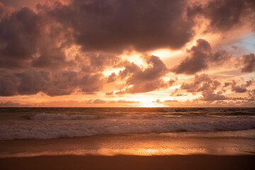 Fototapeta na wymiar Orange sundown and golden sunset sky.Sunset turquoise colored water on the beach.