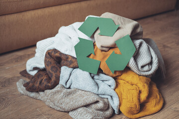 Recycle clothes concept. pile of old autumn clothes on the floor home. High quality photo