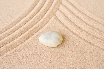 Zen garden stone Japanese on raked sand. rock or pebbles on beach design outdoor for meditate peace of mind and relax. chan Buddhism religion concept.