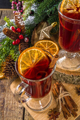Mulled wine, traditional hot winter autumn alcohol boozy drink, with cinnamon, anise and orange, On Christmas decorated background copy space