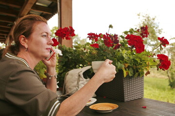 Woman drinks coffee in a cafe and thinks