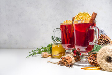 Mulled wine, traditional hot winter autumn alcohol boozy drink, with cinnamon, anise and orange, On Christmas decorated background copy space