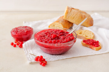 Composition with red currant jam and bread on light background
