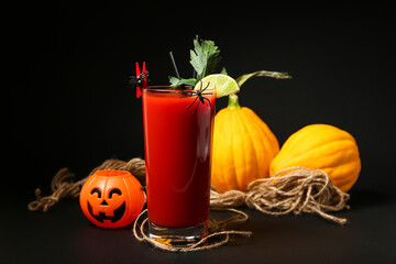 Glass of tasty bloody Mary cocktail decorated for Halloween on dark background
