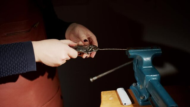 the process of twist the cord with pliers in studio by female hands