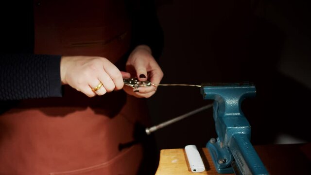 the process of twist the cord with pliers in studio by female hands