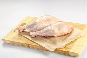 Raw chicken leg over background