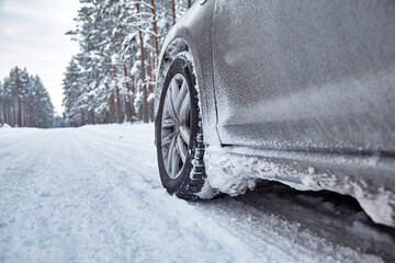 Car on snowy road in forest in winter