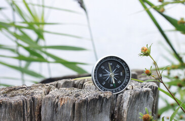 Classic navigation compass on natural background as symbol of tourism with compass, travel with compass and outdoor activities with compass