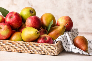 Tray with ripe pears and apples on light background, closeup