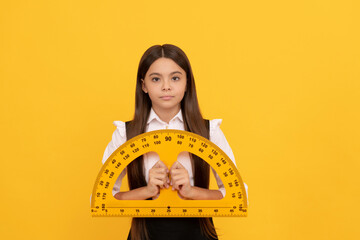 serious child in school uniform hold mathematics protractor for measuring, high school