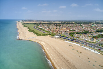 Goring by Sea beach with the Cafe in view and the greensward behind the beach at this popular seaside resort. Aerial view.