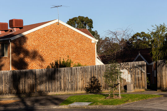 Brick house in peaceful suburb street.